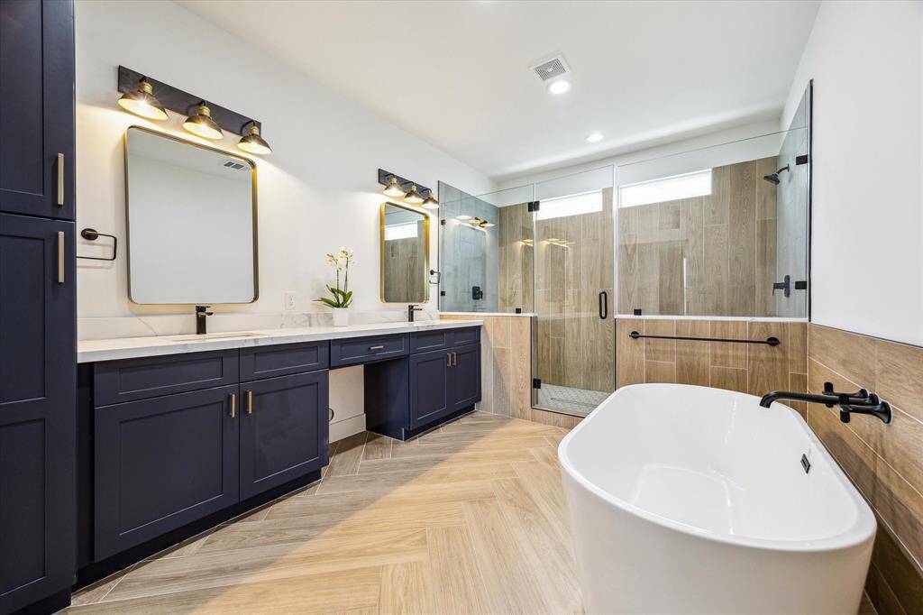 Gorgeous primary bath with dual vanity, high end finishes, soaking tub and walk-in shower!