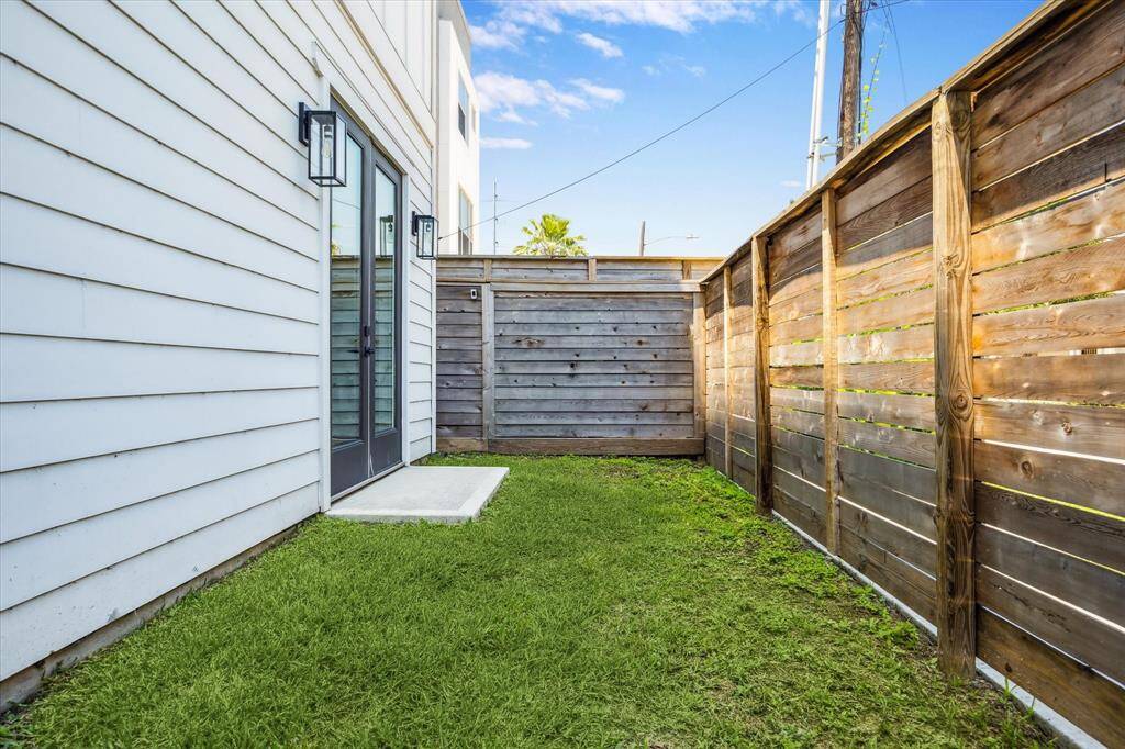 Large side yard that is fully fenced and just off the first floor bedroom.