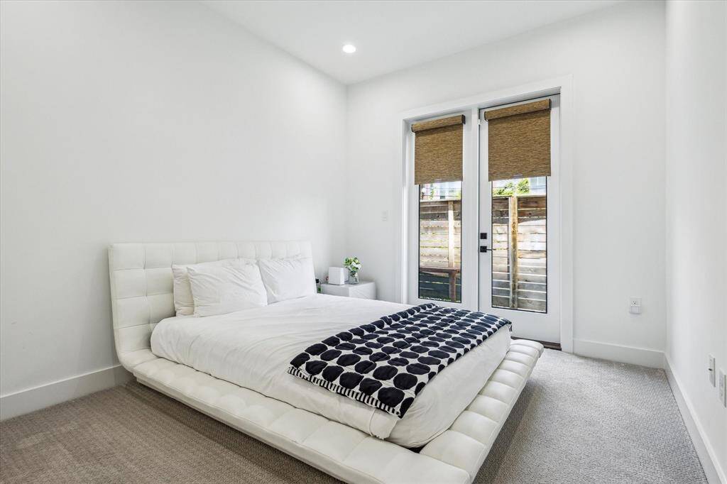 This first floor bedroom offers a lovely en-suite bath and french doors leading out to a spacious side yard!