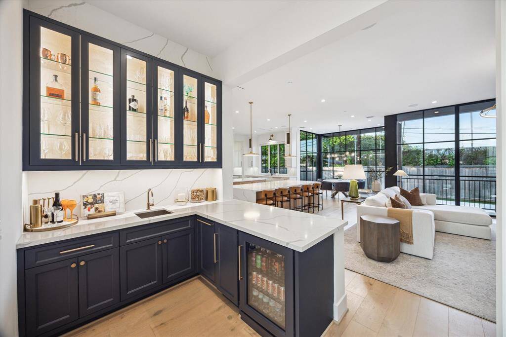 [BAR/BUTLER'S PANTRY] Seamlessly connected to the kitchen and living areas, the bar and butler’s pantry is a beautifully designed extension of the home’s entertaining space. Glass-front display cabinets with integrated lighting showcase your finest glassware, while generous counter space and abundant storage offer both function and flair.