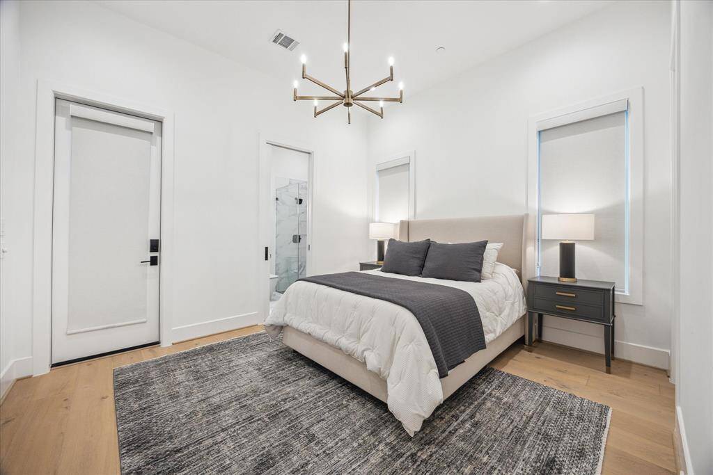 [GUEST BEDROOM SUITE] The spacious first-floor guest suite offers comfort and privacy, ideal for extended stays or multi-generational living.