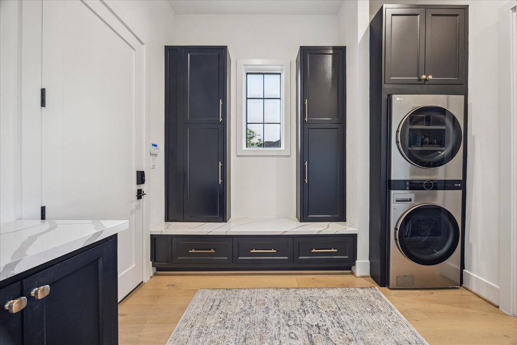 [MUDROOM] The expansive mudroom is thoughtfully designed for everyday ease, featuring a sleek stackable washer and dryer, built-in storage, and ample space to keep life organized.