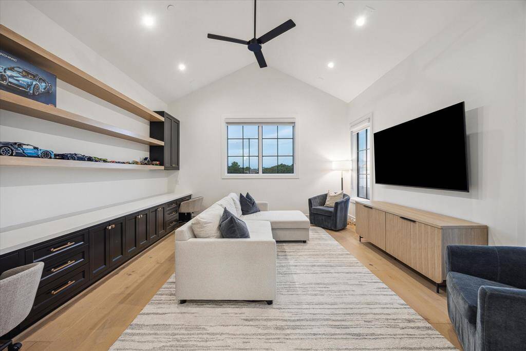 Designed with both fun and function in mind, this space offers generous built-in shelving and thoughtfully integrated storage, making it easy to keep games, media, and entertainment essentials beautifully organized.