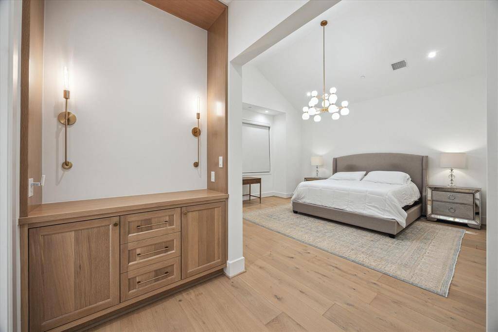 [PRIMARY BEDROOM] Step through a stylish entrance foyer into the grand primary bedroom—a serene sanctuary that exudes contemporary elegance. Spacious and thoughtfully designed, this luxurious retreat is an intimate haven within the home