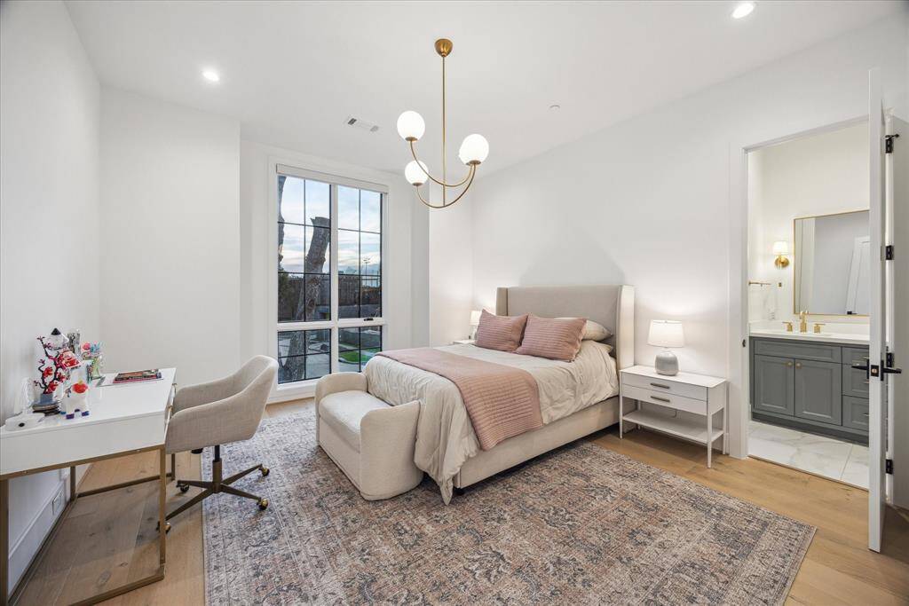 [SECONDARY BEDROOM] This spacious secondary bedroom is bathed in gentle natural light, highlighting soft, soothing colors that create a calm and inviting retreat