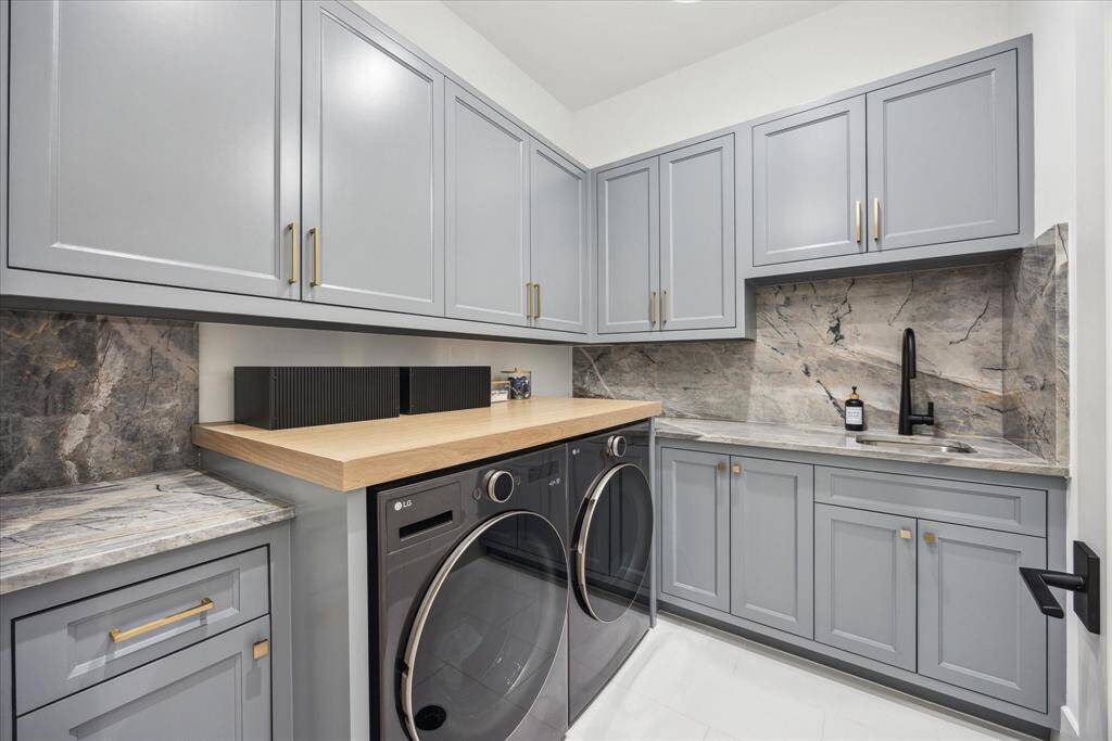 [UITILY ROOM] The utility room is both functional and beautifully designed, featuring ample storage, a deep utility sink, and striking stone surfaces paired with sophisticated color palettes. Clean lines and thoughtful finishes elevate this everyday space, bringing a touch of contemporary elegance to your home's practical needs