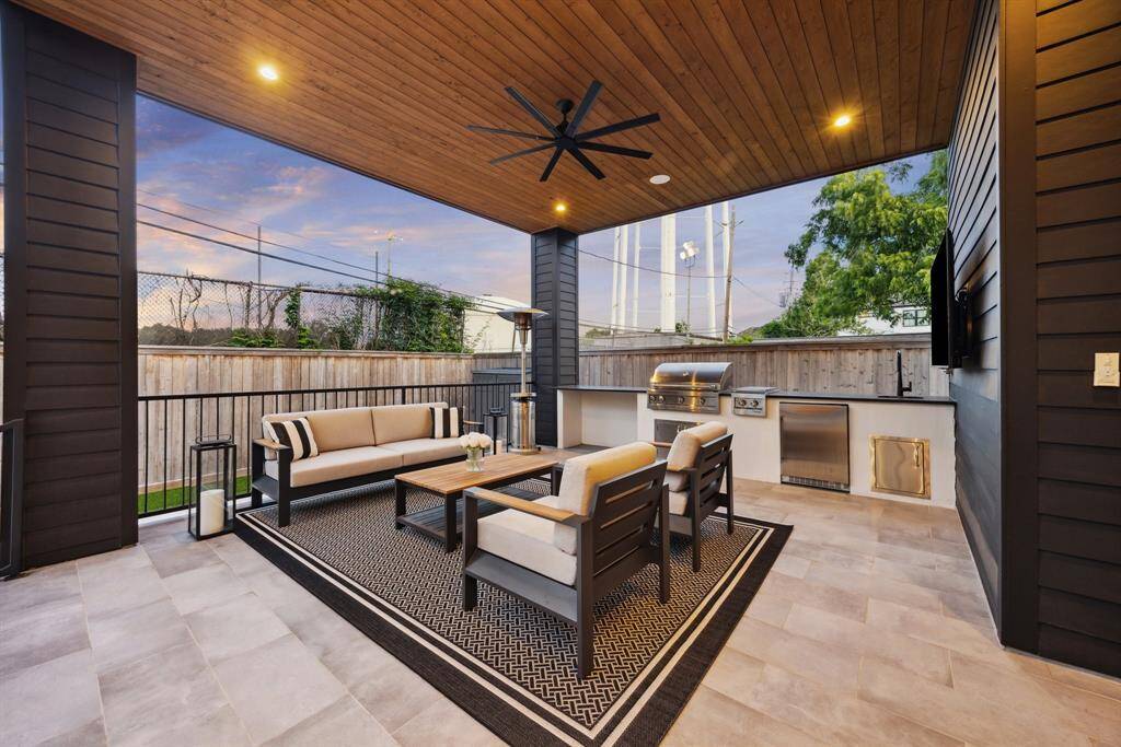 [VERANDA/SUMMER KITCHEN] Experience the art of indoor-outdoor living on the expansive, covered veranda, where oversized glass doors blur the line between the home's elegant interior and its outdoor sanctuary. Thoughtfully designed for effortless entertaining, this sophisticated space features a fully equipped summer kitchen, ideal for alfresco dining and relaxed gatherings.