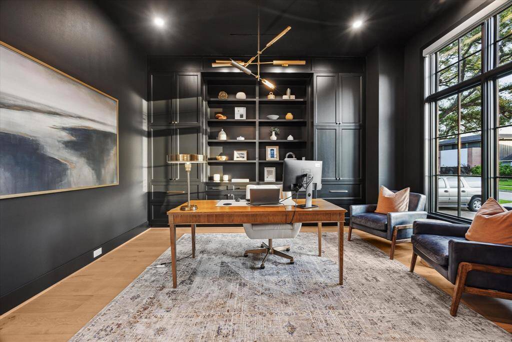 [STUDY/HOME OFFICE] Designed to inspire focus and creativity, the home office exudes modern sophistication with bold, dark-toned walls and custom built-ins that offer both style and function. Soft, ambient lighting enhances the rich palette, while large windows invite in natural light
