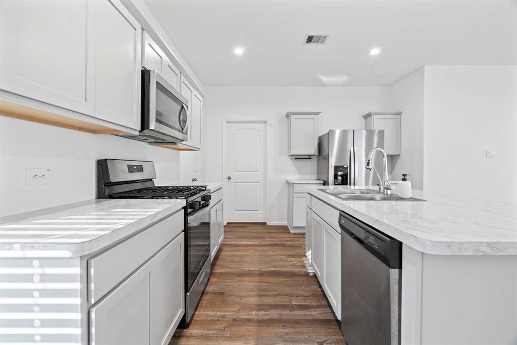 Second-view of kitchen with plenty of stainless-steel