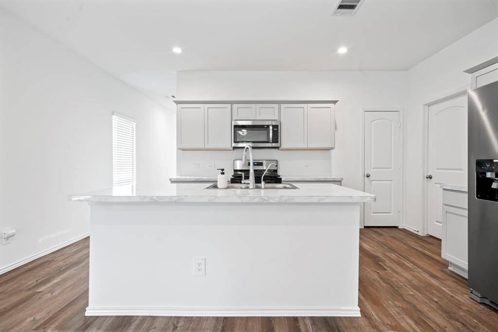 Bright, modern kitchen with spacious island for preparing your favorite recipes