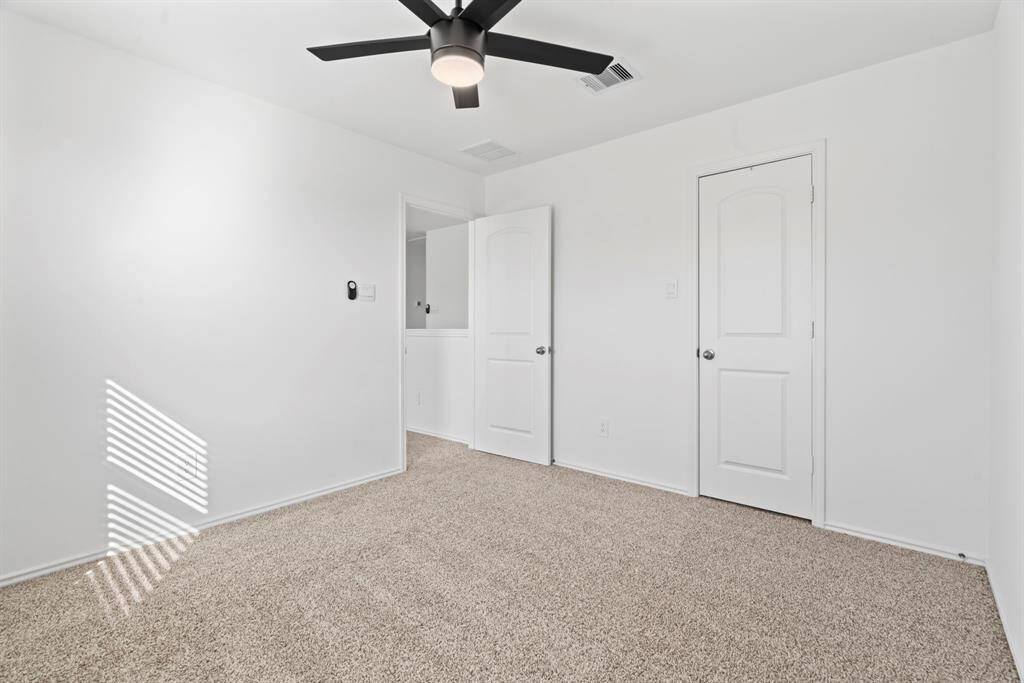 Additional view of the secondary bedroom featuring ample closet space.