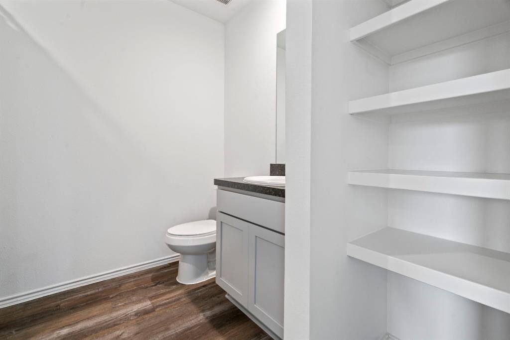 Upstairs full bathroom with built-in shelving for convenient storage