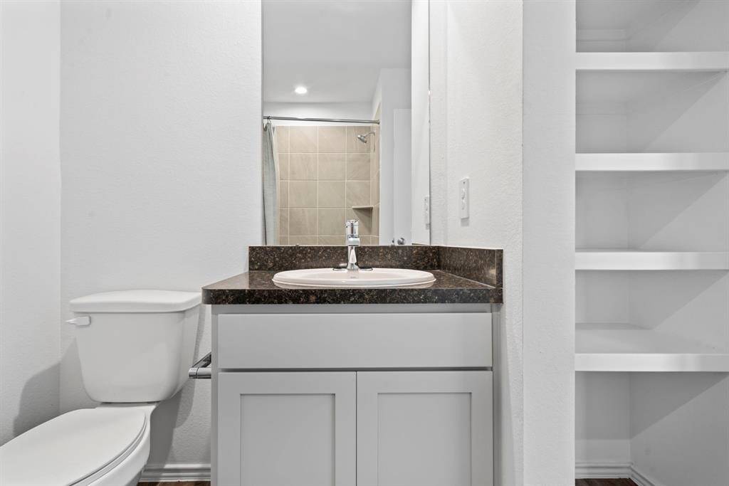 Full bathroom upstairs with a sleek vanity