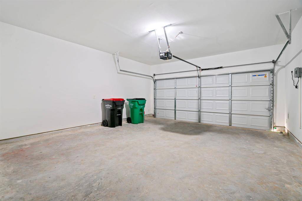 Spacious two-car garage with automatic door opener which also provides room for storage