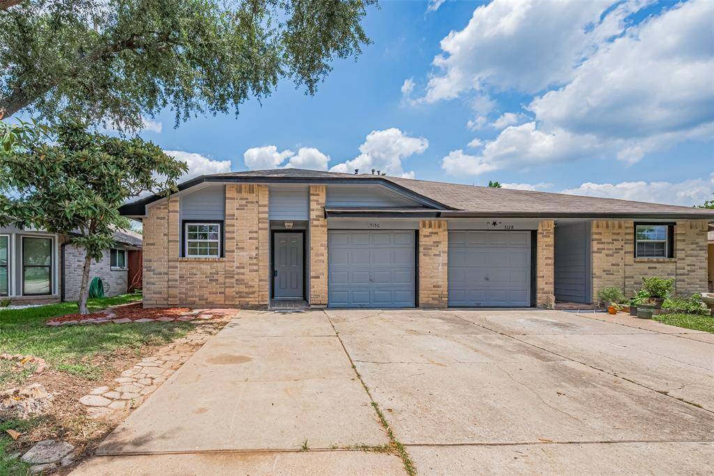 Nestled on a quiet corner lot, the warm brick facade offers a grounded sense of welcome.
