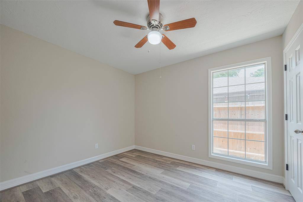 A nearly full-height window brings the outside in, infusing this bedroom with natural light and energy.