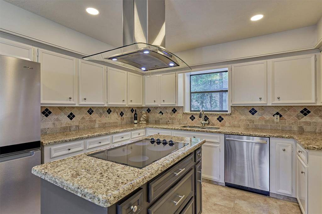 Beautiful central island with electric cooktop and vent hood. Tons of prep space!