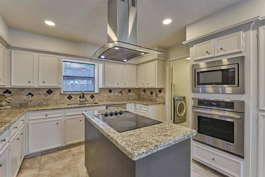 Built-in stainless steel oven and microwave. Note: utility room access.