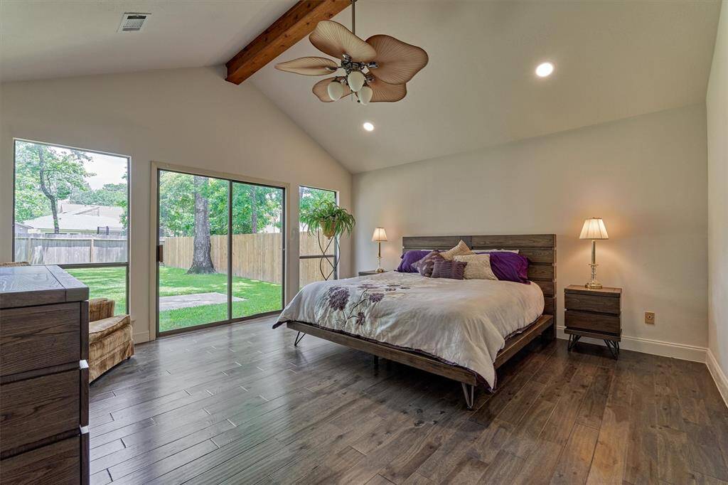 Stunning! The primary retreat is naturally lit with expansive windows to the backyard and wood beamed ceiling.