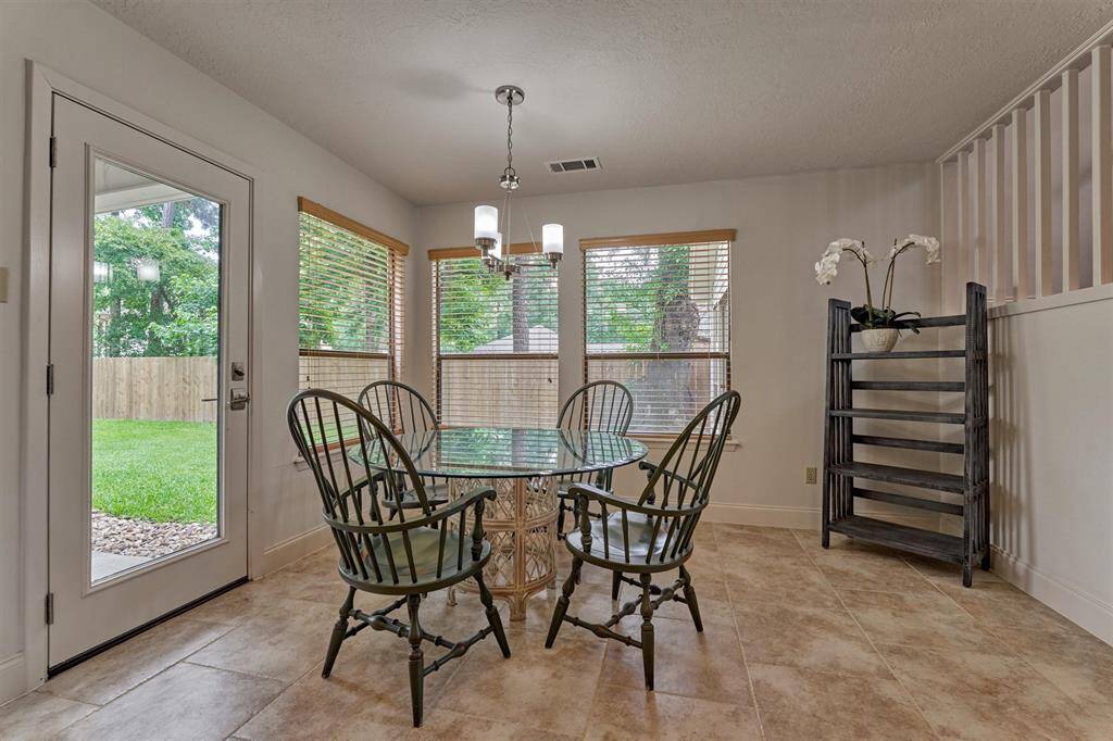 Tile flooring flows between the kitchen and breakfast rooms. So much natural light!