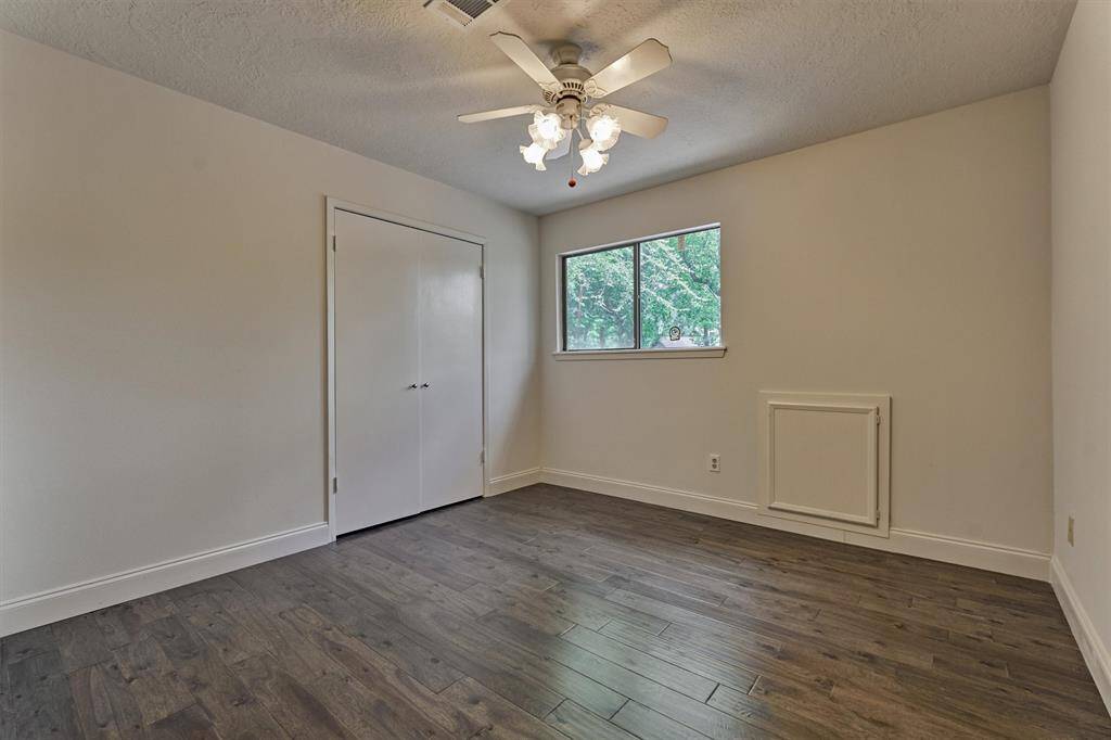 Secondary bedroom #2 boasts wood flooring, ceiling fan, and double door closet.