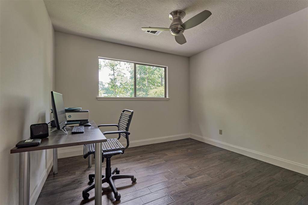 Secondary bedroom #3 features wood flooring, ceiling fan, and closet. Notice, these rooms could be a flex space for home office.