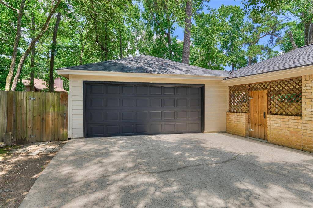 Oversized detached 2-car garage with gate to covered patio and backyard.
