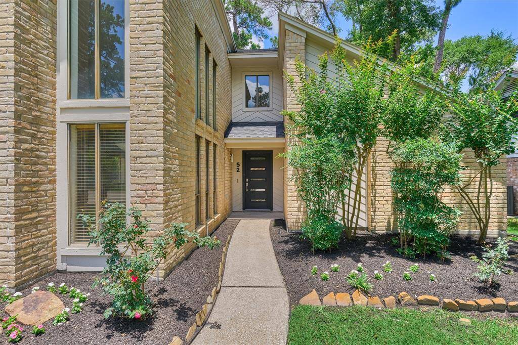Gorgeous light brick exterior with freshly painted siding and trim.