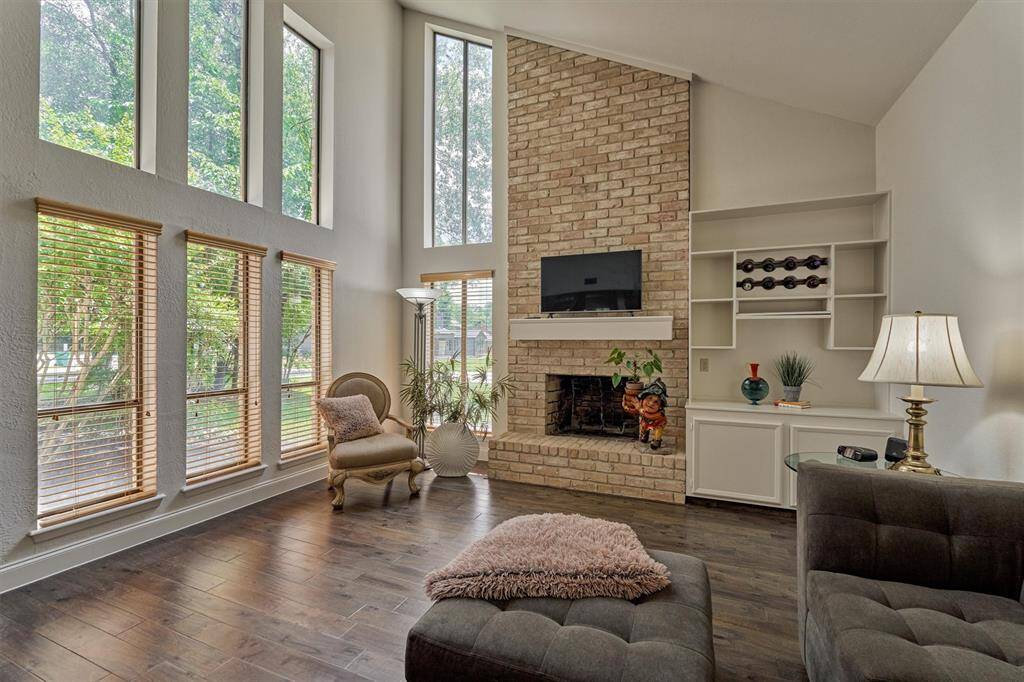 This den is spacious and features a floor-to-ceiling brick fireplace and dry bar with wine bottle capacity.