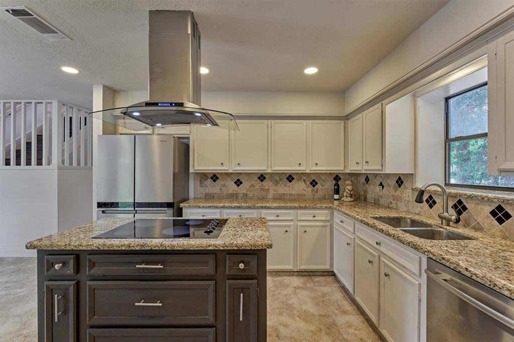 Granite countertops and porcelain tile backsplash.