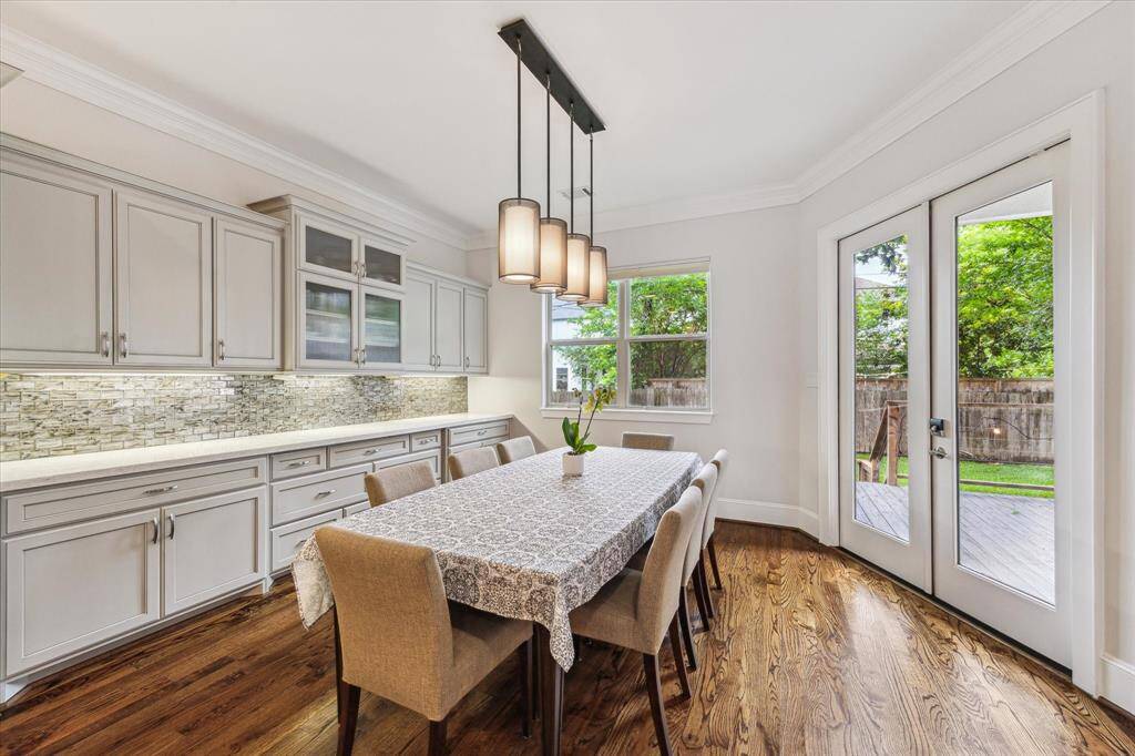 The spacious breakfast area is perfect for enjoying meals and offers views of the backyard.