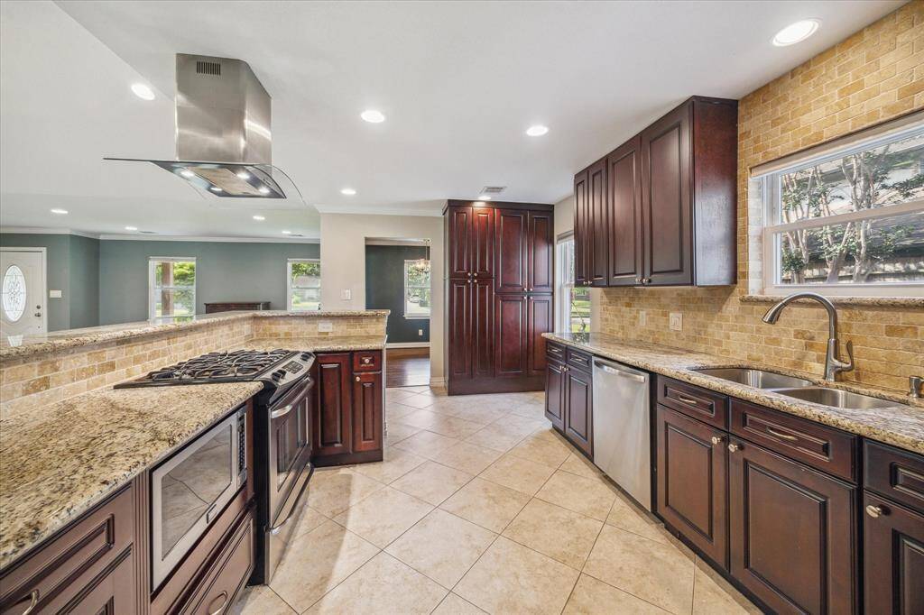 View of the kitchen from back entrance, additional storage/pantry added to match the cabinets.