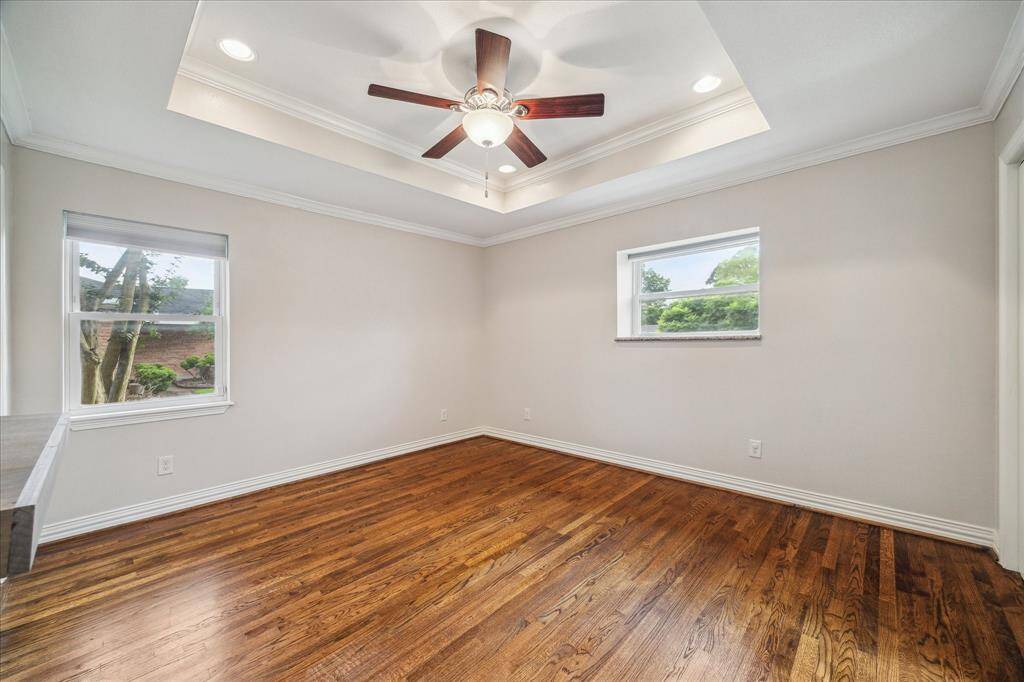 Primary Bedroom with Tray Ceiling and Crown Molding.