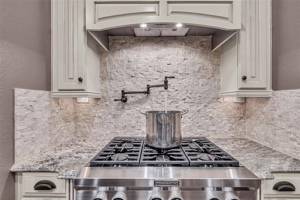 The pot filler over the gas cooktop is an essential element to a serious kitchen!