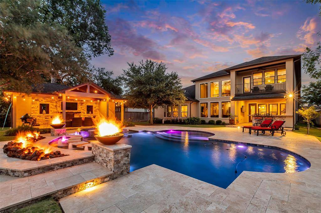 This backyard is spectacular.  Complete with outdoor kitchen, pool with water and fire features and a covered cabana to watch the game or a movie.  Did we mention there is a half bathroom in the cabana as well?