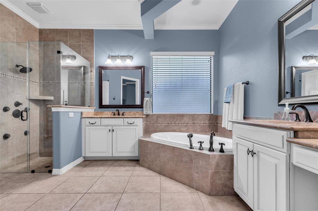 Primary ensuite bathroom is well designed for modern living. The glass enclosed shower and separate tub are essential for today's lifestyle.