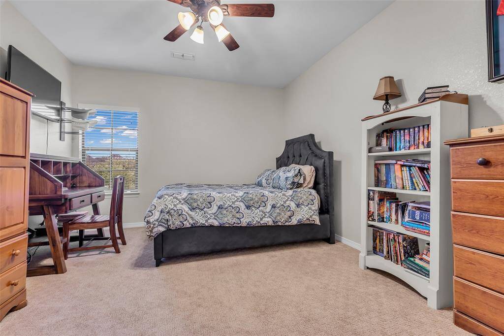 These two bedrooms share a hollywood bathroom with separate vanities.