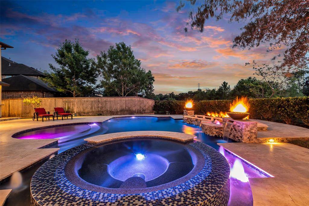 Feel the stress of the day melt away in this spa with fire and sunset views.  Simply Marvelous!  Make an offer today and make this YOUR pool this summer.