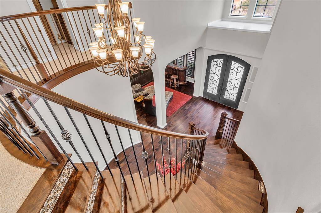 Elegant spiral staircase winds through the foyer elevating the space.