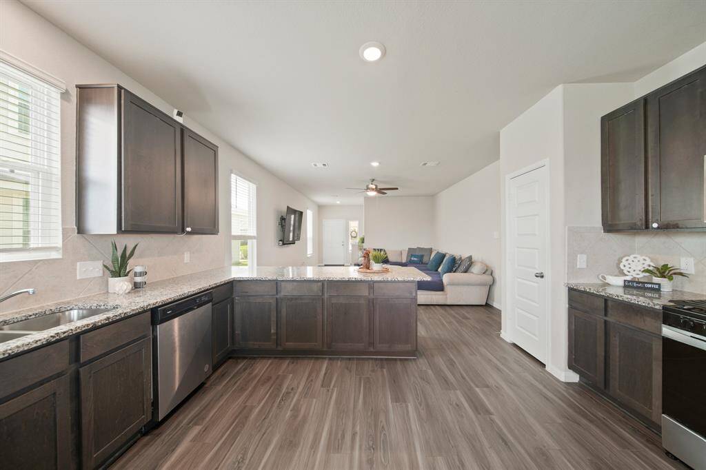 Another view of how open the massive kitchen is to the family room -- this is truly the heart of the home! And the neutral color pallet makes it ideal for any home decorations.