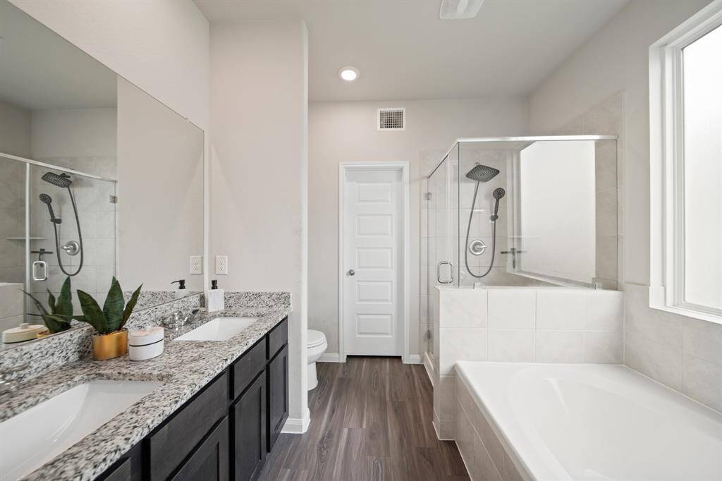 The 5-piece ensuite bath features double sinks, granite counter tops, a soaker tub and a large walk-in shower. Behind the door is a large walk-in closet, making getting ready for the day such a breeze.