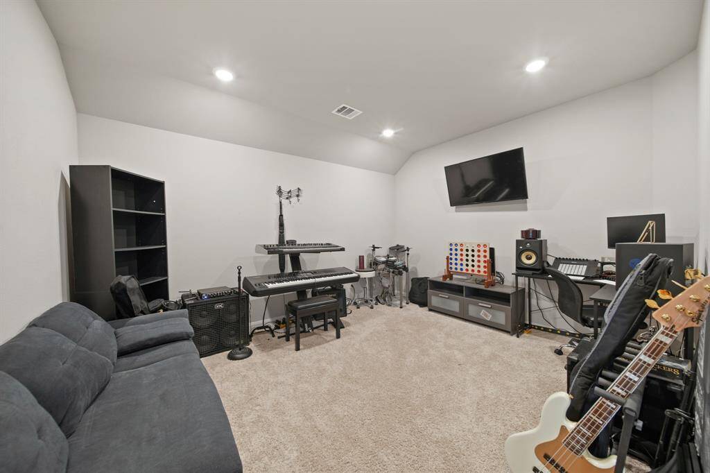 The large media room is currently being used a music room. On the builder's original floor plan this was an option for Bedroom #5.