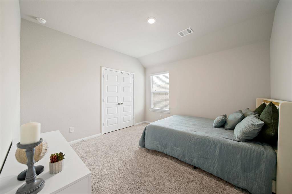Bedroom #2 is spacious and has a nice double-door closet. The high ceilings and neutral paint and carpet color make the room feel even larger.
