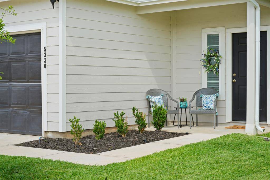 This charming front patio is a great place to connect with neighbors or to greet the kids when the get off the school bus. Imagine relaxing on this front porch.