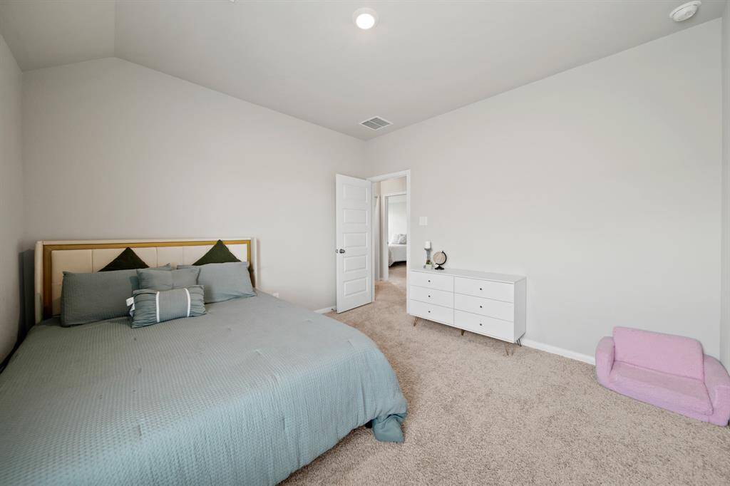 Bedroom #2 has neutral colors and energy-efficient LED lighting.