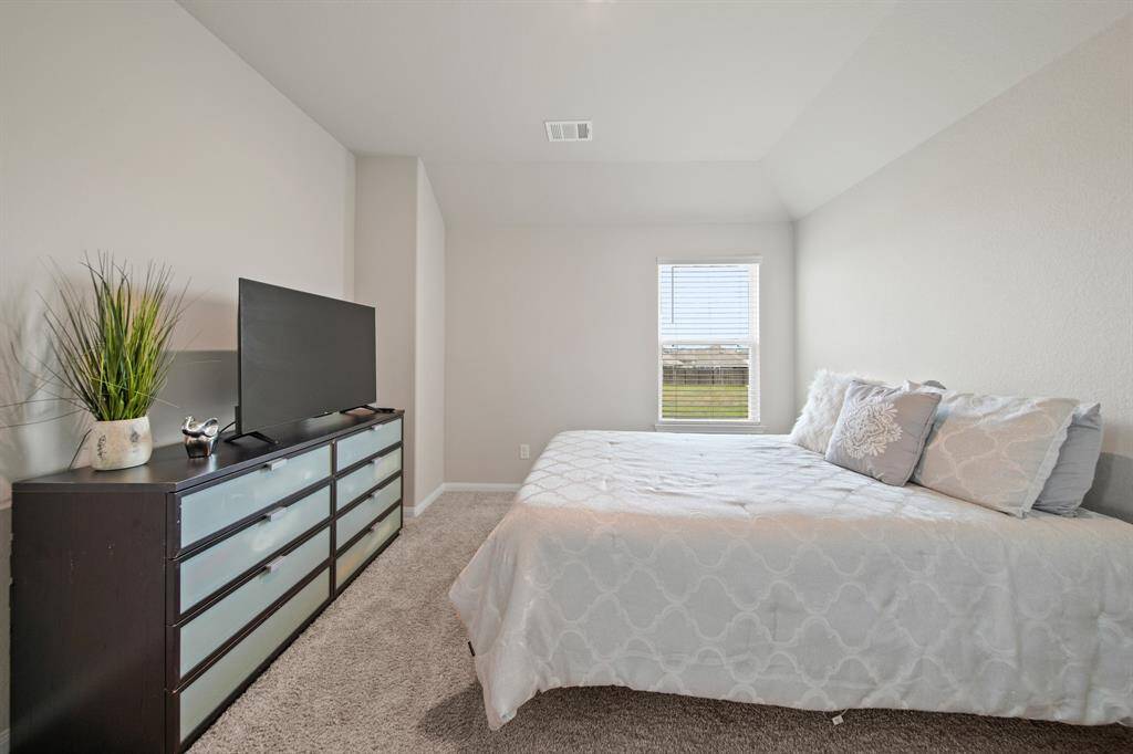 Another view of Bedroom #3 featuring neutral colors, LED lighting and a beautiful window.