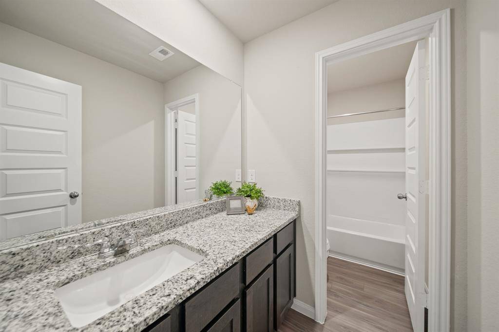 All the bedrooms on the second floor share this well-appointed bathroom. The separation between the shower/toilet room and the granite vanity with sink make get ready easier for family members.