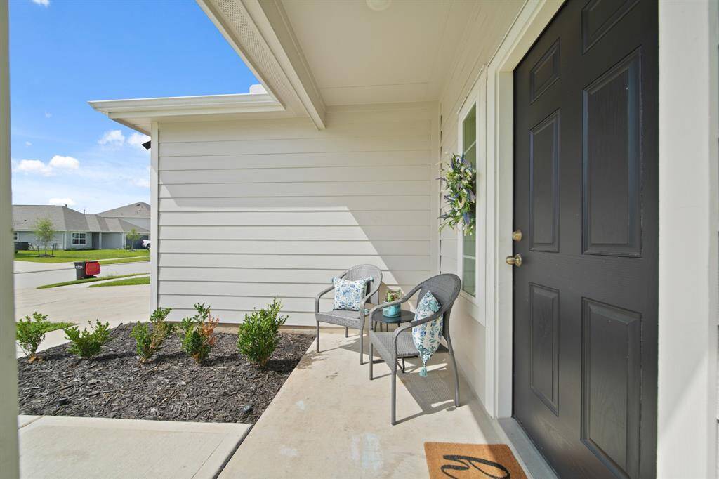 Another view of the charming front porch. Large enough for a bench seating or a small bistro table and chairs.