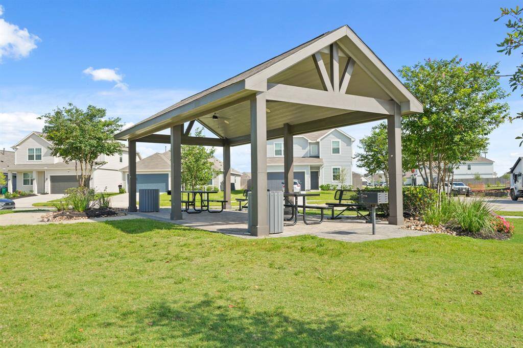 This neighborhood pavilion is a great place to gather with neighbors or host a large family event. It features covered seating, trash receptacles, lush landscaping and a BBQ grill.