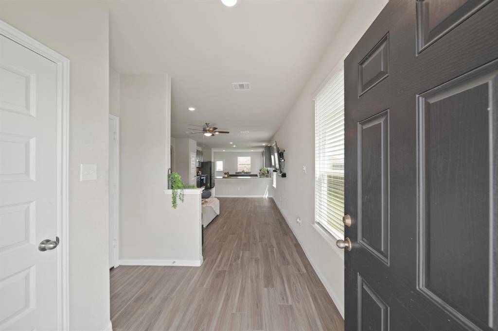 As you enter you will notice the incredible open concept floorplan (the largest in the community) and the kid-friendly and pet-friendly LVP flooring. (The door on the left is a storage closet.)